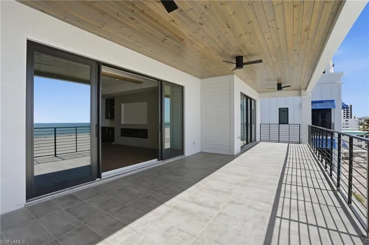 Balcony with a ceiling fan and a water view