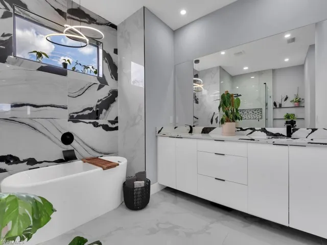 Bathroom featuring tile floors and double vanity
