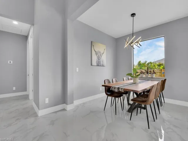 Tiled dining area with a chandelier