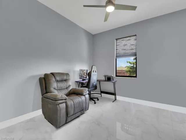 Living area with tile floors and ceiling fan