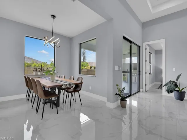Dining room with a chandelier and light tile floors