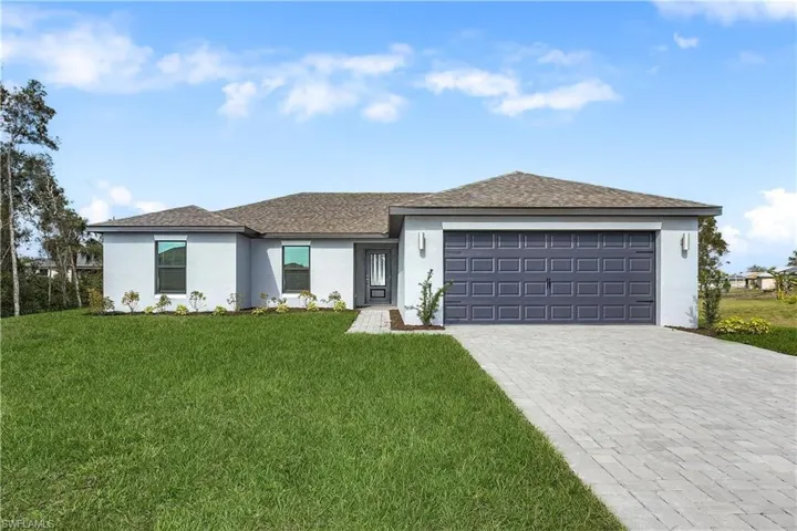 View of front of property featuring stucco siding, a garage, decorative driveway, and roof with shingles