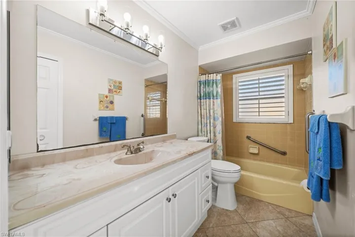 The guest bathroom, complete with decorative lighting, also serves as a pool bath.