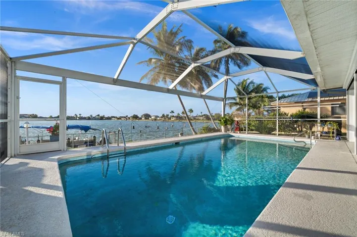 Take note of the stamped concrete lanai floor, the pool ladder, and the pool entrance bar. All enhancements.