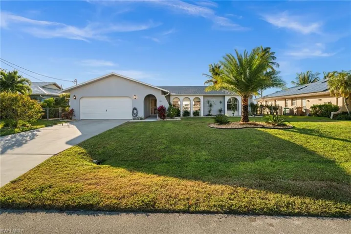 Single story home featuring stucco siding, concrete driveway, a front lawn, and an attached garage.