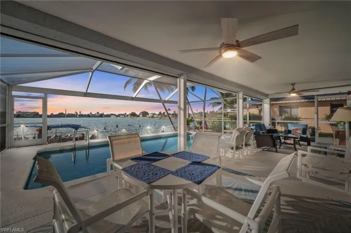 Notice the sunset. Notice the electric hurricane screens. The screens make this outdoor space - indoor space with the flip of a switch!