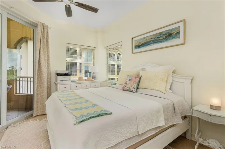 Bedroom with ceiling fan, crown molding, and light hardwood / wood-style floors