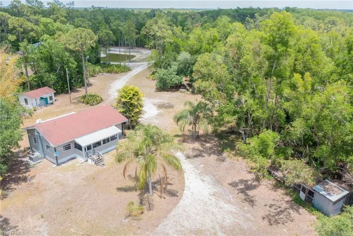 View from above of property featuring a forest even a little chicken coop