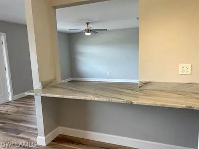 Kitchen with wood finished floors and a ceiling fan