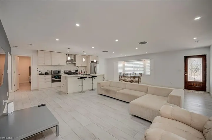 Living room featuring light wood-style floors and recessed lighting