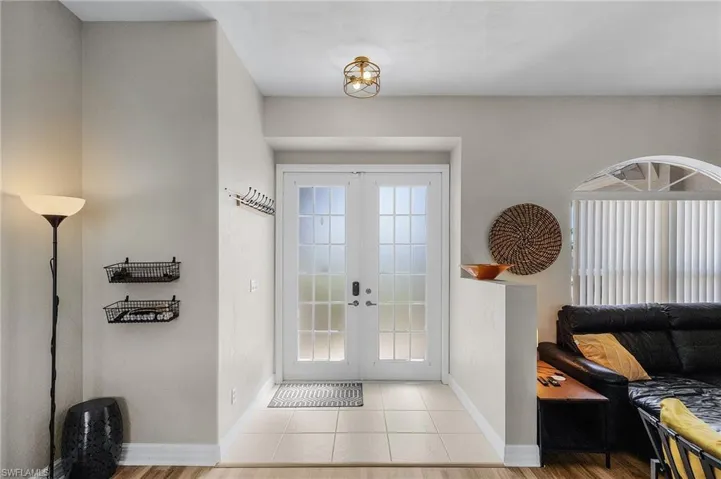 Doorway featuring french doors and tile patterned flooring