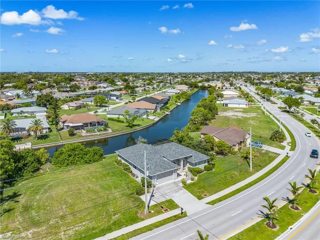 Aerial perspective of suburban area featuring a large body of water