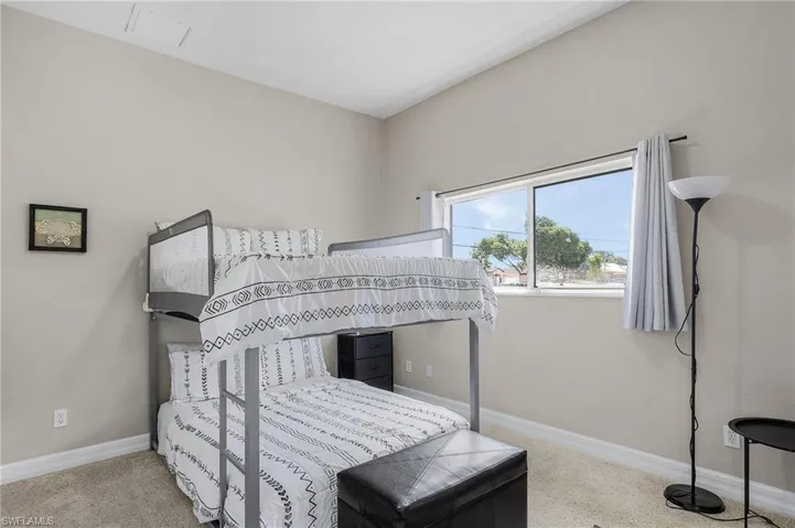 Carpeted bedroom with baseboards