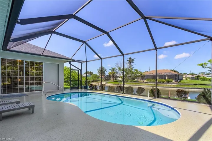 Swimming pool featuring a patio area and a water view