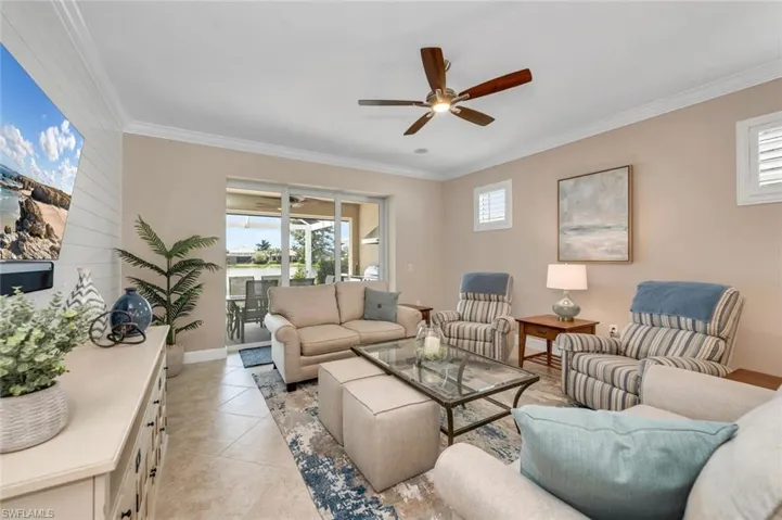 Living room featuring crown molding, and a wealth of natural light