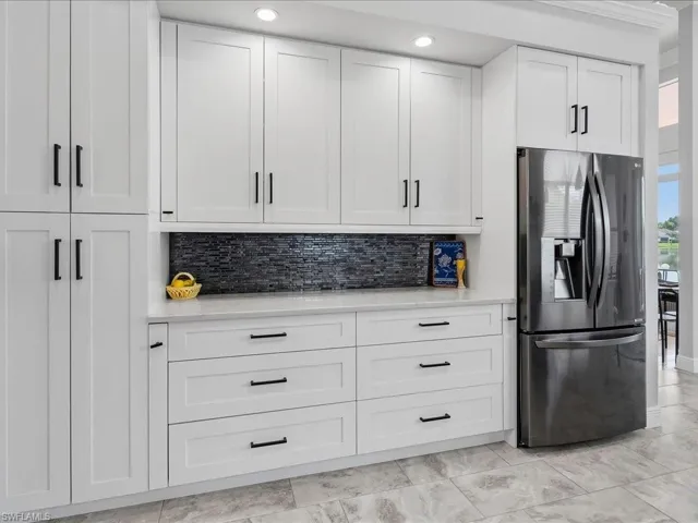 Contrasting glass tile backsplash showing pantry and lots of drawers!