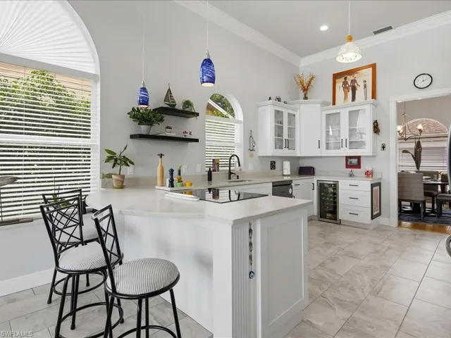 Recently renovated bright kitchen with stainless appliances, wine cooler, quartz counters and views of the lake.