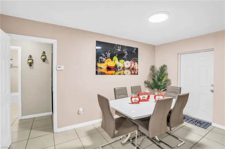 Dining space featuring light tile patterned flooring