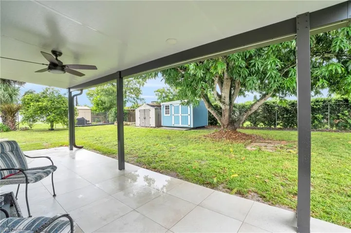 View of patio / terrace with a storage unit and ceiling fan