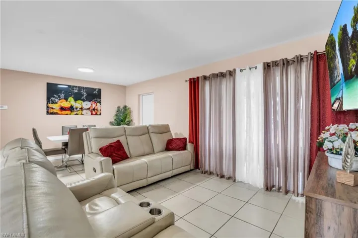 Living room with light tile patterned floors