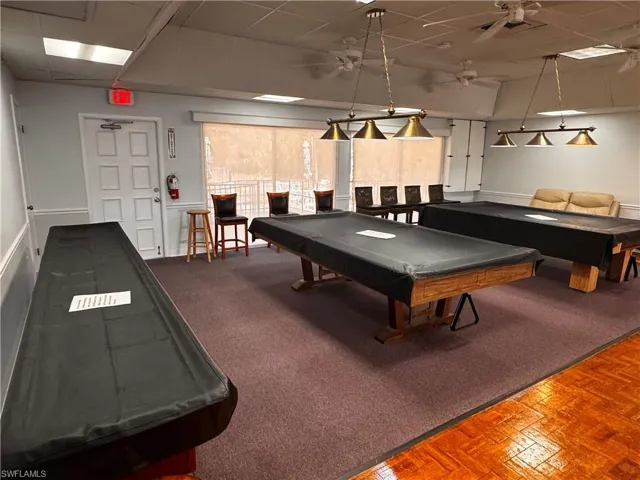 Playroom featuring a paneled ceiling, pool table, and ceiling fan