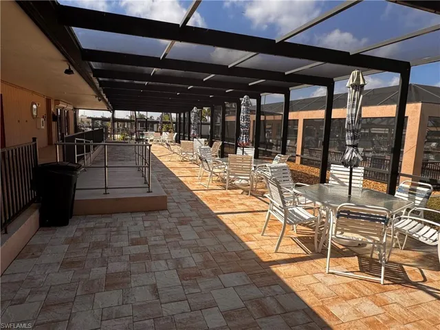View of patio featuring a lanai and outdoor dining area