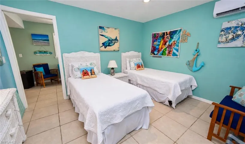 Light-toned tile flooring throughout the interior, featuring a wall-mounted ductless air conditioning unit