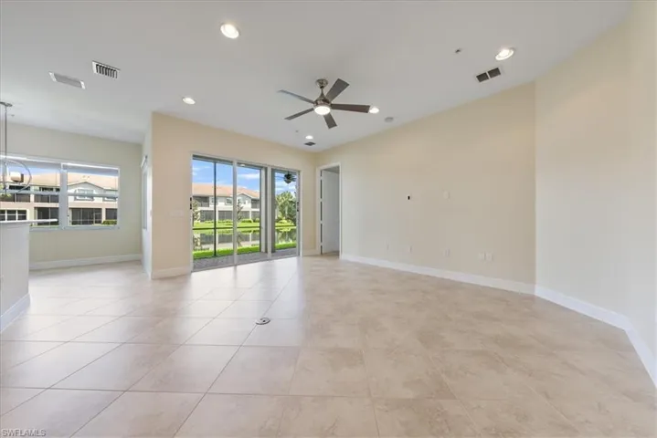 Spare room with plenty of natural light, ceiling fan, and light tile patterned floors
