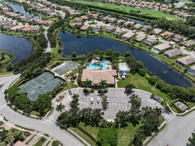 Birds eye view of property with a water view
