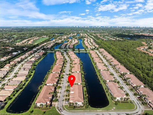 Birds eye view of property with a water view