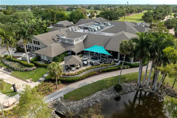 Rear View of Clubhouse, Outdoor Bar, Bocce Courts and Outdoor Seating Area.