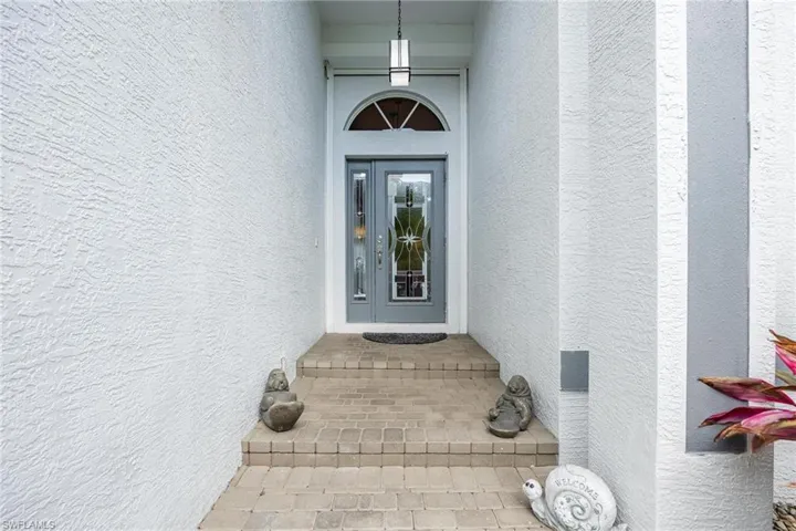 Main Entrance with New Light Fixture and Electric Hurricane Shutter.