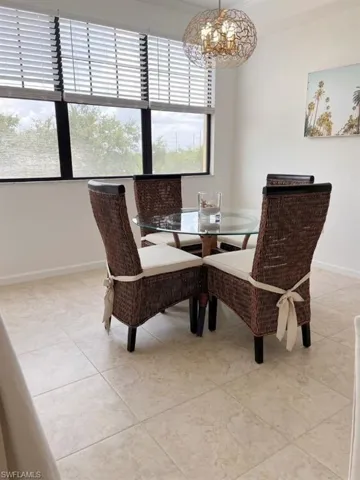 Dining room with a chandelier and light tile patterned floors