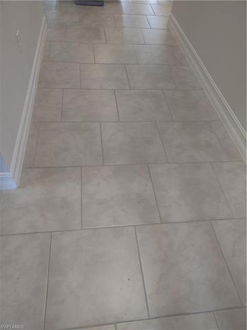 Tile flooring throughout kitchen, bathrooms and living/dining area
