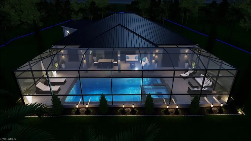 Back of house at twilight featuring glass enclosure, a sunroom, an outdoor pool, and a metal roof