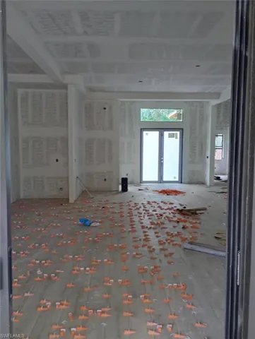Empty room with healthy amount of natural light and french doors