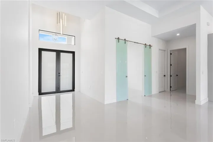 Enter through the COVERED FRONT PORCH andGRAND DOUBLE DOORS into a SOARING 16-FTFOYER, where a NEUTRAL PALETTE OF WHITE,LIGHT GRAY, and CASHMERE WELCOMES YOUHOME!