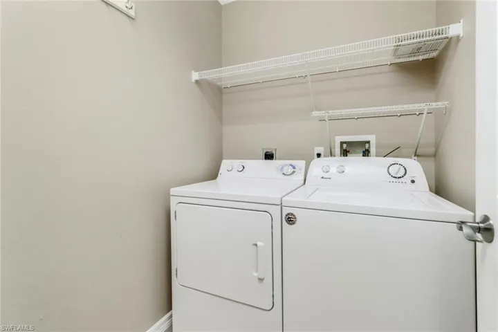 Washroom featuring laundry area and washer and dryer
