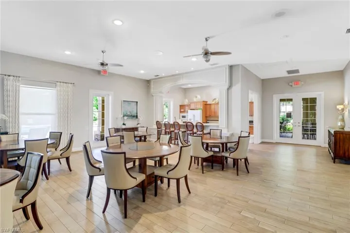 Dining area featuring light hardwood / wood-style floors, ceiling fan, and a wealth of natural light
