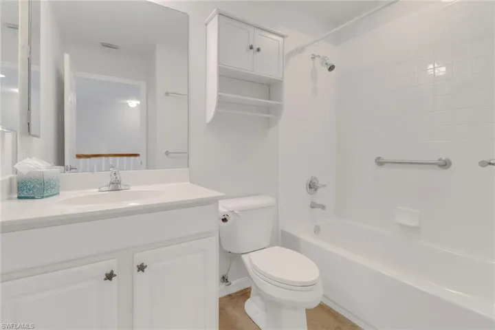 Full bathroom with tub / shower combination, vanity, and toilet