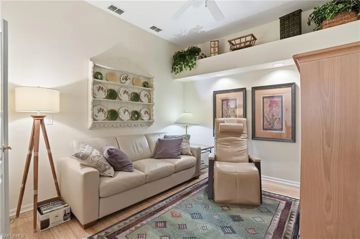 Living area with wood finished floors and a ceiling fan