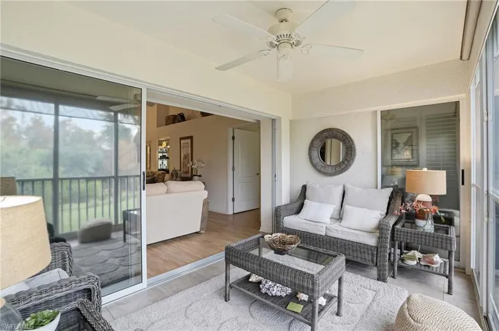 Sunroom featuring an indoor / outdoor hangout area with view of golf course