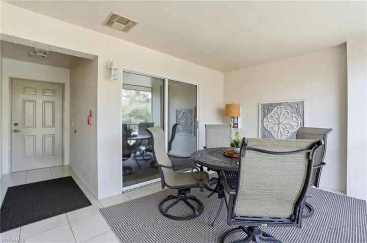 Outdoor room featuring a textured wall and tile patterned floors