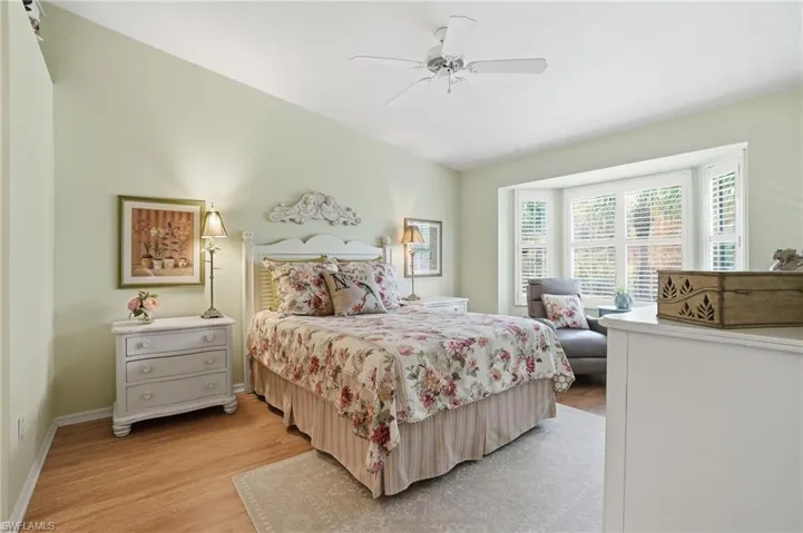 Bedroom with light wood finished floors and a ceiling fan