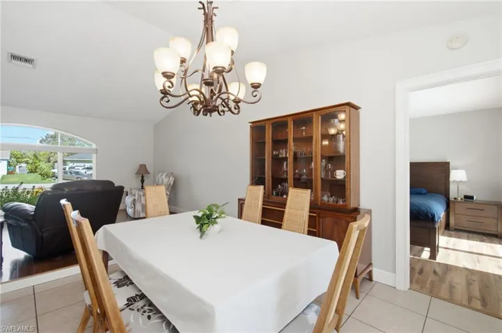 Dining area featuring a decorative chandelier and tile flooring