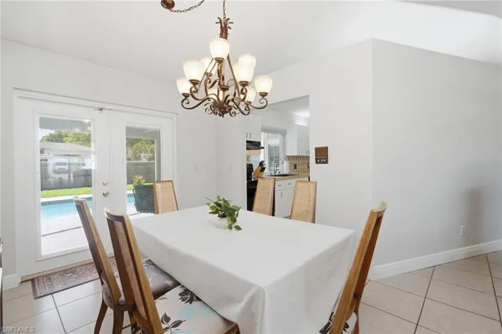 Dining area featuring a decorative chandelier and tiled flooring
