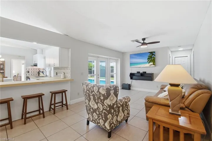 Open-concept living space featuring tile flooring and a ceiling fan