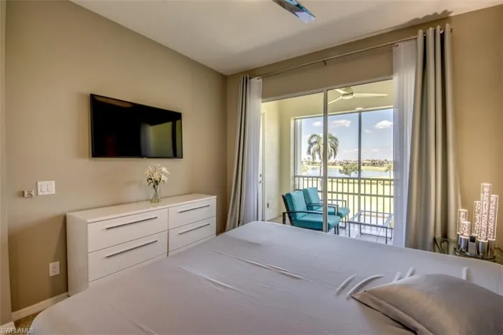 Bedroom featuring access to outside and baseboards