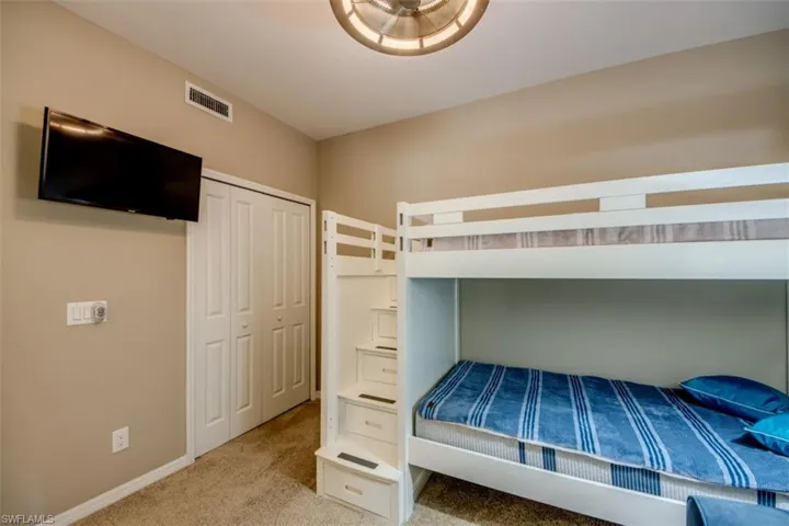 Unfurnished bedroom featuring a closet, baseboards, carpet, and visible vents