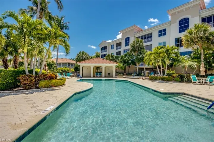 Pool with a patio and fence
